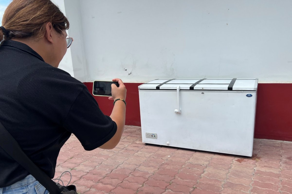 A Thai reporter takes a photo of an empty freezer at the Nong Prue police station in Pattaya, Chonburi Province, Thailand, on July 11, 2023. (AP Photo)