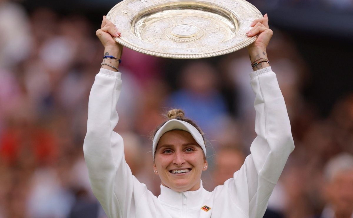 Czech Republic's Marketa Vondrousova celebrates with the trophy winning her final match against Tunisia’s Ons Jabeur during the 2023 Wimbledon tennis championships at The All England Lawn Tennis and Croquet Club, in London, Britain, on July 15, 2023. (Andrew Couldridge/Reuters)