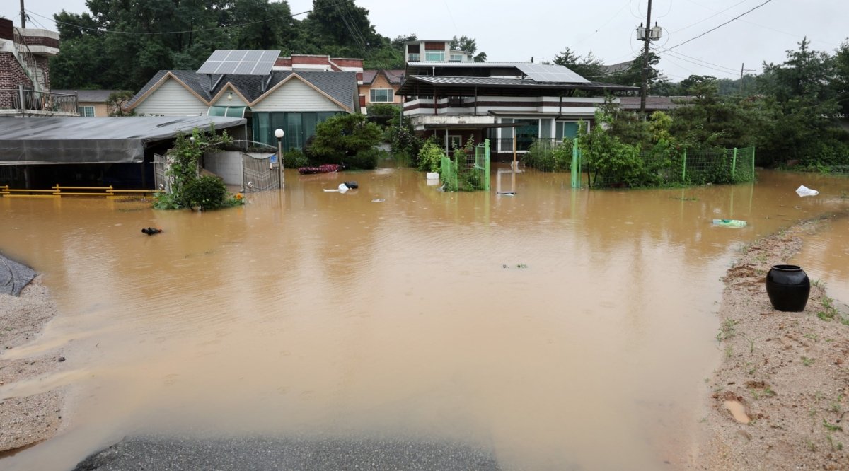 Housing partly submerged by a flooded river caused by heavy rain in Cheongju, South Korea, on July 15, 2023. (Yonhap via Reuters)