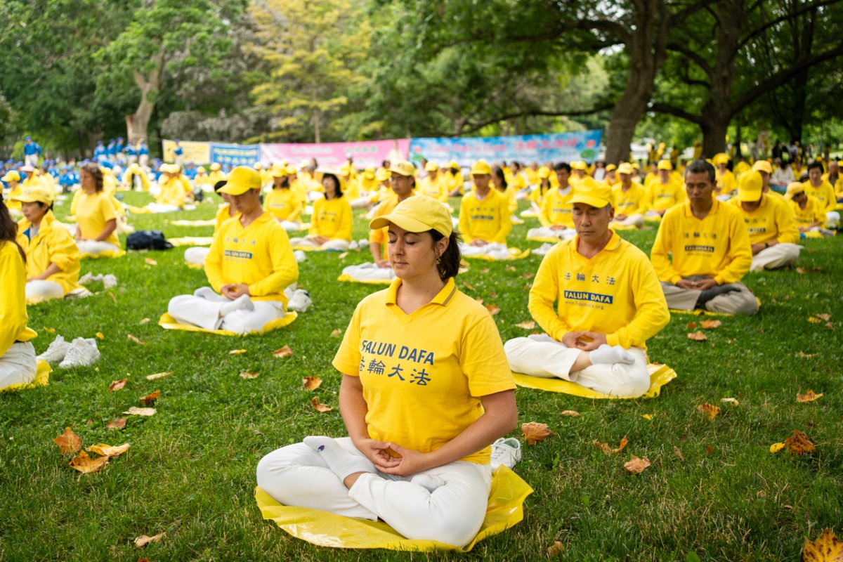 Falun Gong adherents perform the fifth exercise of the meditative practice at Queen's Park in Toronto, Ontario, on July 15, 2023. Hundreds of Falun Gong practitioners took part in a rally and a parade through the city's downtown area, calling on the Chinese regime to stop the ongoing persecution against the spiritual practice. (Evan Ning/The Epoch Times)