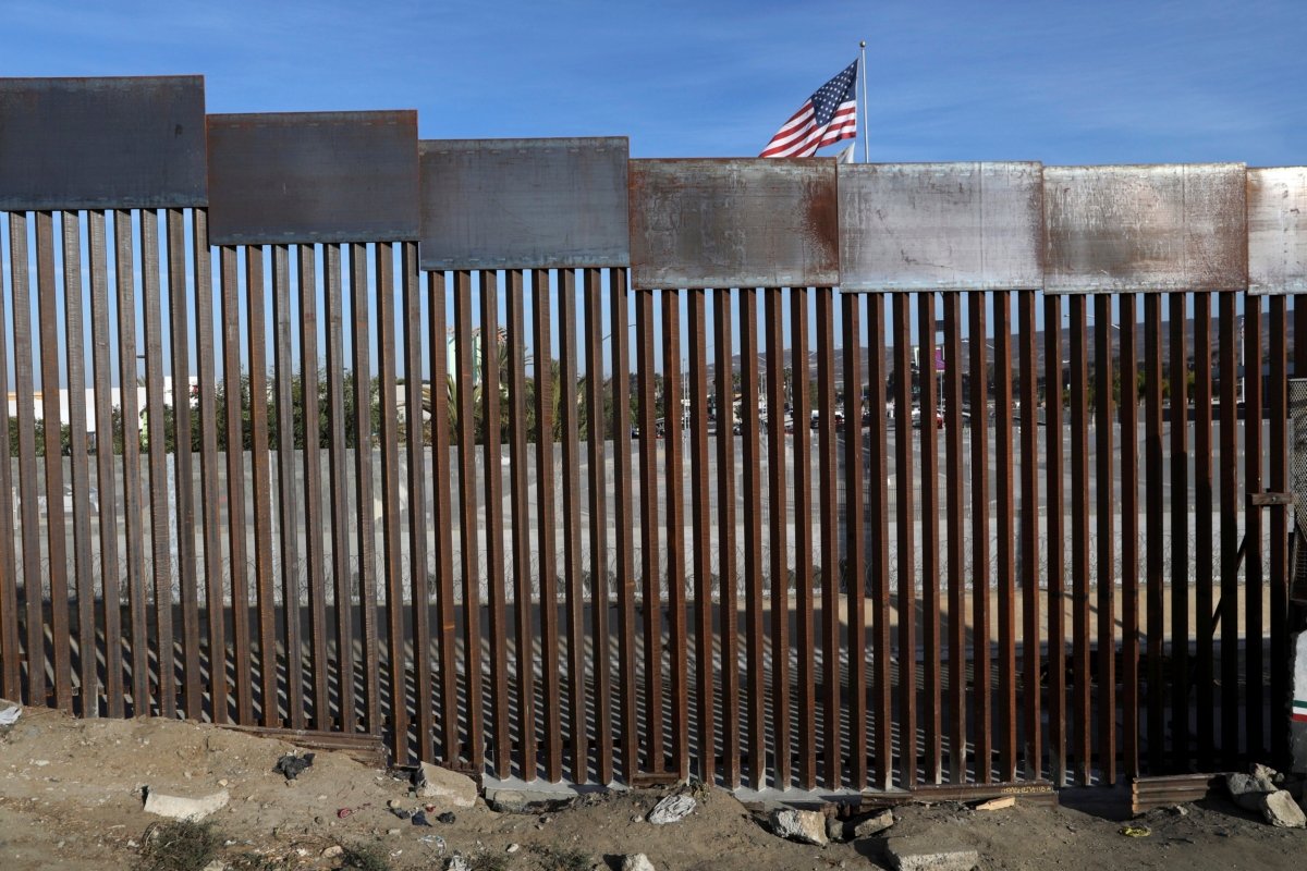 A U.S. flag flies behind the border fence that divides Mexico and the U.S. in Tijuana, Mexico, on Nov. 21, 2018. (Rodrigo Abd/AP Photo)