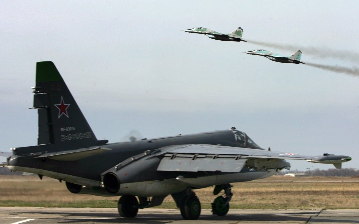 Russian SU 25 SM ground attack aircraft (ground) and MIG 29 jet fighters (taking off) attend a training session at Primorkso-Akhtarsk in Krasnodar region, Russia, on March 26, 2015, ahead of the Russian commemoration of the 70th anniversary of the capitulation of Nazi Germany in 1945. (Sergey Venyavsky/AFP via Getty Images)