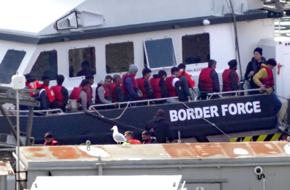 A group of illegal immigrants are brought by a Border Force vessel to Dover, Kent, on July 18, 2023. (Gareth Fuller/PA Media)