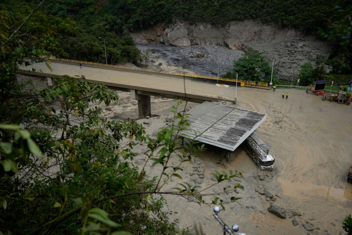 A truck is covered by mud under a bridge that collapsed during a deadly avalanche that also smothered some homes in El Naranjal, Colombia, on July 18, 2023. (Fernando Vergara/AP Photo)