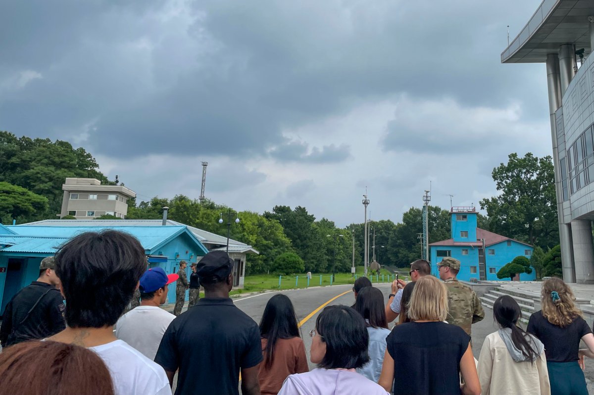A group of tourists stand near a border station at Panmunjom in the Demilitarized Zone in Paju, South Korea, on July 18, 2023. (Sarah Jane Leslie/AP Photo)