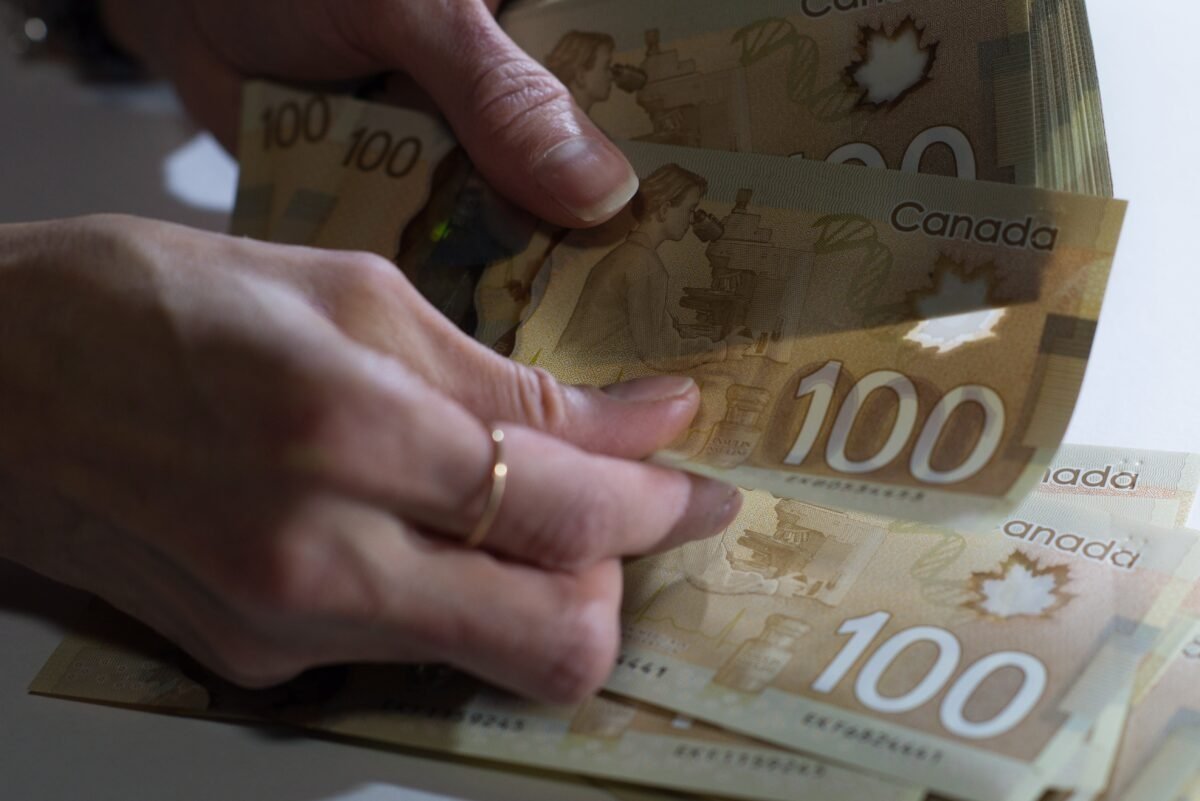 Canadian $100 bills are counted in Toronto on Feb. 2, 2016. (The Canadian Press/Graeme Roy)