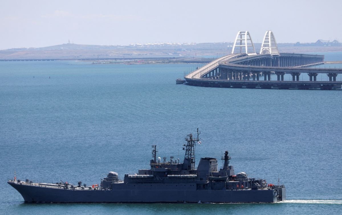 A Russian Navy amphibious landing ship that was deployed to transport cars across the Kerch Strait, moves near the Crimean Bridge as seen from the city of Kerch, Crimea, on July 17, 2023. (Alexey Pavlishak/Reuters)