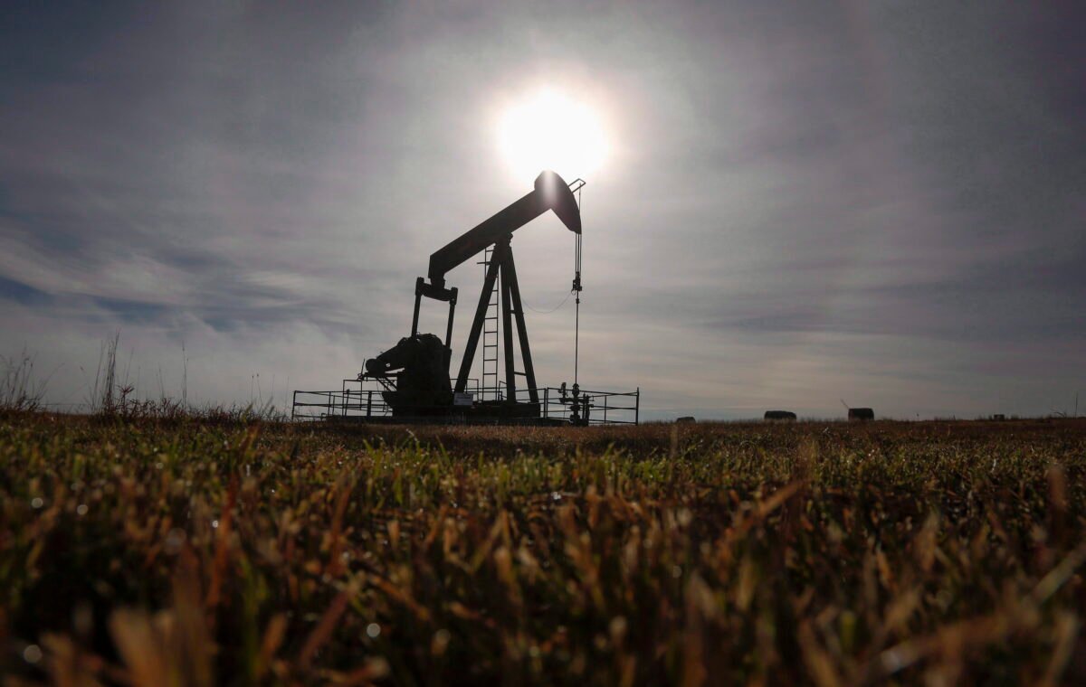 A pumpjack works at a well head on an oil and gas installation near Cremona, Alta., in a file photo. (Jeff McIntosh/The Canadian Press)