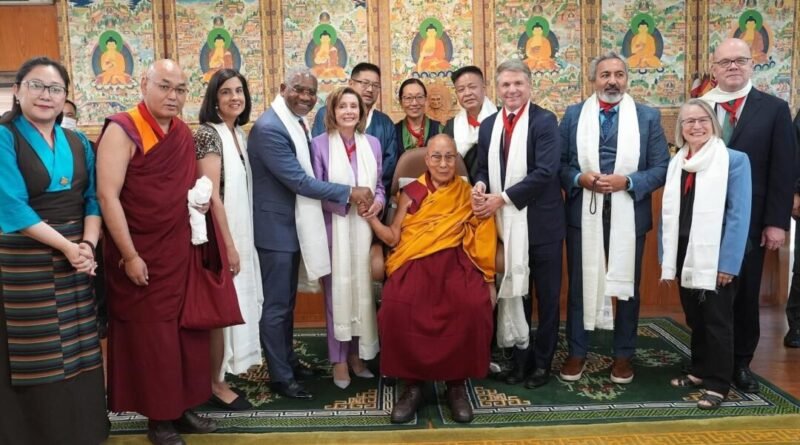 A traditional Tibetan scroll or thangka is presented to former U.S. Speaker of the House Nancy Pelosi (D-Calif.) during the visit of a congressional delegation to the 14th Dalai Lama, in Dharamshala, India, on June 18, 2024.